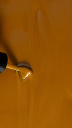 close up of golden yellow ochre gel polish color 