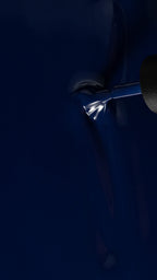 close up of a indigo blue color with a polish brush running through it