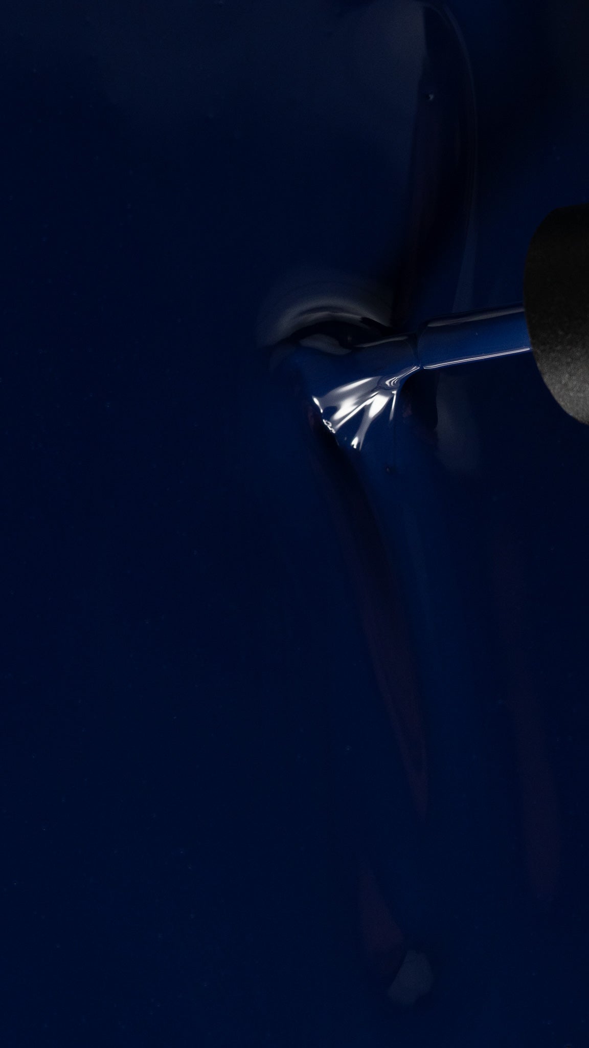 close up of a indigo blue color with a polish brush running through it