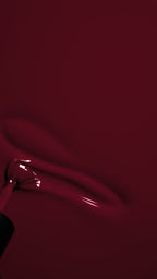 close up of a brush running through a rich berry gel polish 