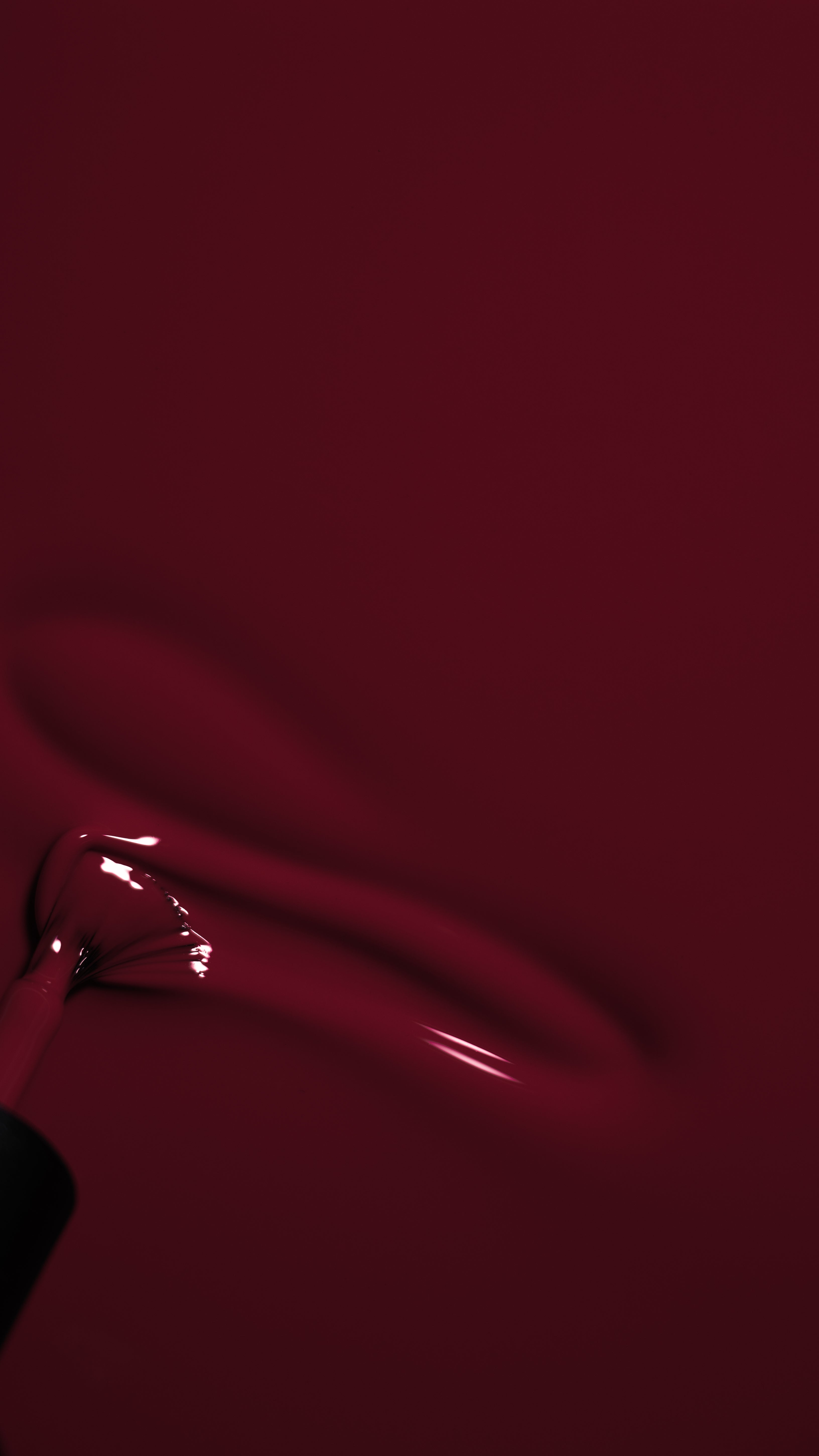 close up of a brush running through a rich berry gel polish 